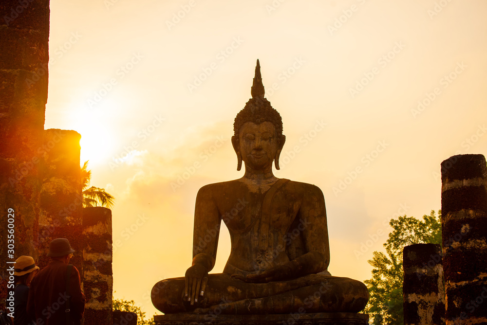 Sukhothai Wat Mahathat Buddha statues at Wat Mahathat ancient capital of Sukhothai  Thailand. Sukhothai Historical Park is the UNESCO world heritage. - obrazy, fototapety, plakaty 