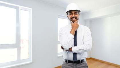 Sticker - architecture, construction business and people concept - smiling indian male architect in helmet over empty new apartment room background