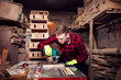 © Novak - Young blonde man working with wood in his garage