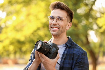 Canvas Print - Handsome male photographer with camera outdoors