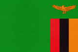 Fototapeta  - Republic of Zambia national fabric flag, textile background. Symbol of international world African country.