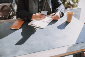 Attractive adult guy working at table outside