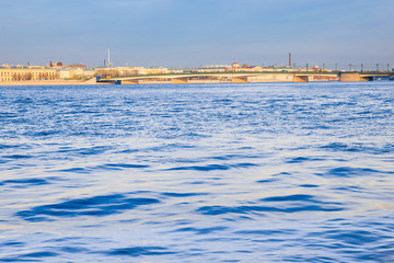 Beautiful landscape with Trinity bridge on a sunny day in the center of St. Petersburg, the Neva river and beautiful blue sky.