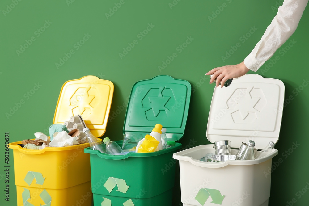 Woman throwing garbage into container. Recycling concept - obrazy, fototapety, plakaty 