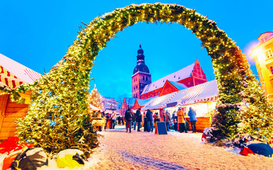 Wall Mural - Entrance to the Christmas Market in Christmas market winter Riga in Latvia. Winter. Late at evening. Street and holiday fair in European city Advent Decoration with Crafts Items on Bazaar