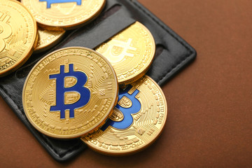 Wall Mural - Wallet with bitcoins on color background, closeup