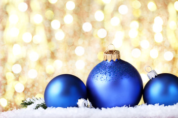 Christmas baubles with white snow on blurred background