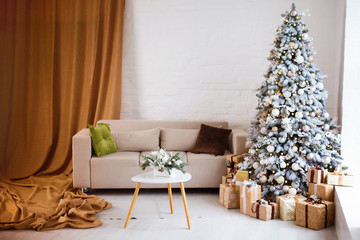 Interior of bright modern living room with comfortable sofa decorated with Christmas tree and gifts