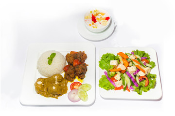 Asian style ramadan sehri food set. Healthy full course meal. A plate of green salad, A plate of plane rice and 2 kind of beef curry with Faluda dessart on white background.