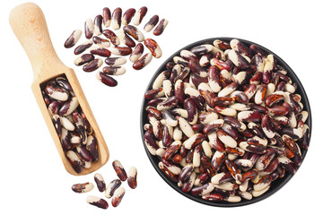 Wall Mural - kidney beans in black bowl with wooden spoon isolated on white background. top view