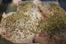 Spicy Seasoned Chicken Legs Or Drumsticks. Grilled Over A Summer Barbecue And Served On Paper On A Rustic Wooden Board.
