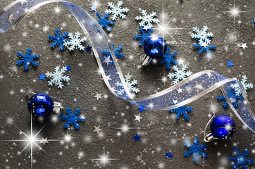 Wall Mural - Blue Christmas background. Curly ribbon with decorative balls and snowflakes.