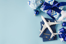 Travel Present For Christmas Or New Year. Toy Airplane With Passports And Gift Boxes.