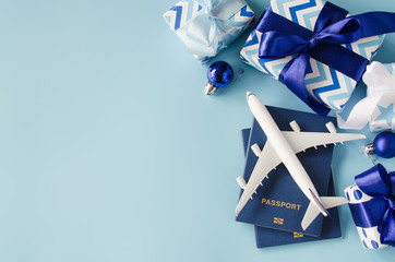 Travel present for Christmas or New Year. Toy airplane with passports and gift boxes.