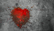  red puddle in the shape of a broken heart on a gray concrete background