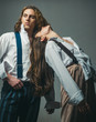 © Volodymyr - Fashion studio photo of beautiful couple in suit. In white shirt. Beautiful adult couple in formal wear posing. Romantic evening of a young couple. Love and trust. Confident couple in smart clothing.