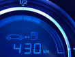 Fuel economy gauge with glowing digital technology indication of mileage remaining to refueling. Close-up fragment of car dashboard. Conceptual photo of energy saving, climate and environment issues.