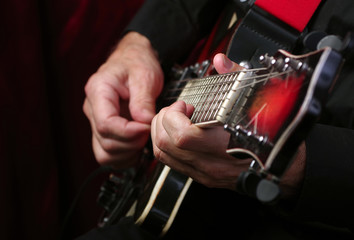 Wall Mural - Guitarist hands and guitar close up. playing electric guitar.