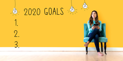 Wall Mural - 2020 goals with young woman holding a tablet computer
