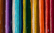 Colorful rainbow of freshly hand dyed yarn hanging on a wall