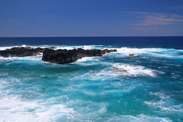  The intense blue sea and the black volcanic rocks