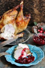 Wall Mural - turkey with cranberry sauce on a plate on Christmas Day. turkey for Christmas. New Year's and Christmas table with turkey