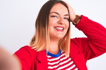 Wall Mural - Beautiful woman wearing striped t-shirt and jacket standing over isolated white background stressed with hand on head, shocked with shame and surprise face, angry and frustrated. Fear and upset 