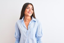 Young Beautiful Woman Wearing Blue Elegant Shirt Standing Over Isolated White Background Looking Away To Side With Smile On Face, Natural Expression. Laughing Confident.