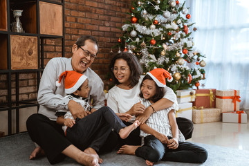 Wall Mural - grandparents and children having fun during christmas day celebration at home with family