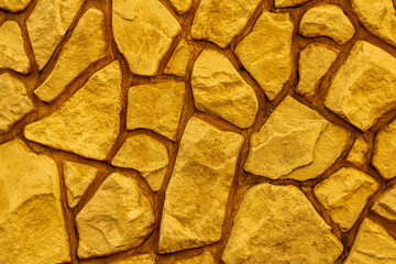 texture fo bright yellow decorative stone , orabge rock abstract background , rough rock close up