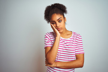 Sticker - African american woman wearing casual pink striped t-shirt over isolated white background thinking looking tired and bored with depression problems with crossed arms.