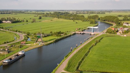 Sticker - High angle shot of the Merwede Canal surrounded by grassy fields captured in Nehterlands