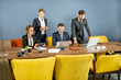 © rh2010 - Group of business people strictly dressed in the suits working during a small conference at the big table in the colorful meeting room