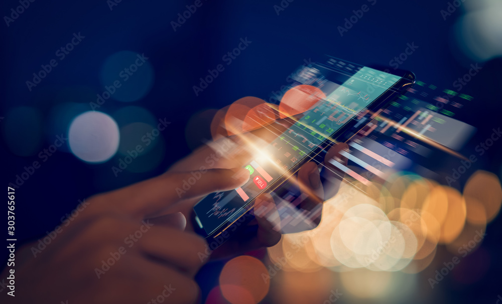 Stock exchange market concept, hand trader touching on smartphone with graphs analysis candle line on bokeh colors light in night atmospheric city. - obrazy, fototapety, plakaty 