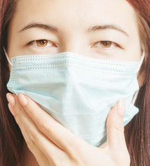 Sticker - Portrait of woman in medical protective mask, looking at camera.