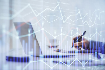 Multi exposure of forex chart with man working on computer on background. Concept of market analysis.