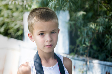 Wall Mural - Portrait of a serious child boy outdoors.