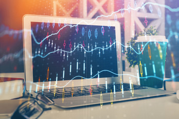 Financial market graph hologram and personal computer on background. Multi exposure. Concept of forex.