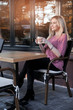 © MagicsPhotos - Beautiful woman drinks cappiccino at sunset outdoors.