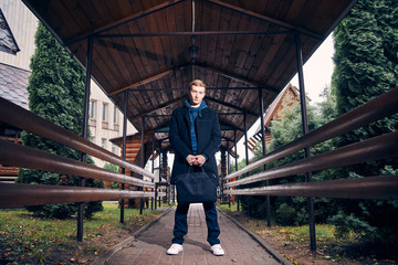 Wall Mural - portrait of a young guy with a suitcase