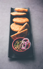 Poster - Fried Sattu Litti chokha served with Baingan Bharta, onion and pickle, popular recipe from Bihar, India