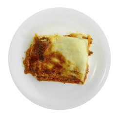 Wall Mural - Portion of tasty lasagna. An isolated traditional lasagna made with minced beef bolognaise sauce. Tasty serving of traditional Italian lasagne with spicy tomato based ground beef and melted mozzarella