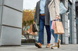 Adult woman and man walking together with shopping bags