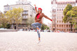© ClaudiK - Fashion portrait of pretty smiling and jumping woman. Joyful happy young woman jumping in city street.Excited beautiful girl portrait. Beautiful dancing girl on a street