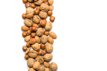 Wall Mural - top view of mix of nuts scattered on white background with copy space