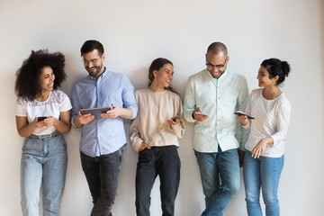 Wall Mural - Happy diverse people having fun with gadgets.