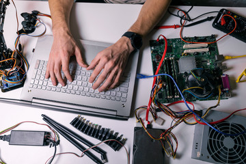 electronics technician working - testing and configuring computer hardware