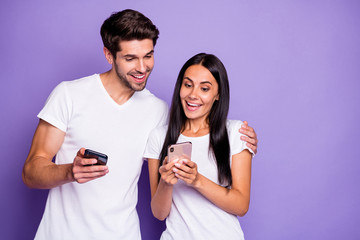 Poster - Close-up portrait of his he her she nice attractive lovely cheerful cheery glad amazed couple using digital device watching media content isolated on purple violet lilac color pastel background