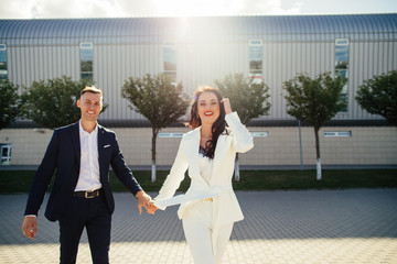 Beautiful loving couple is spending time together. Happy couple while walking through the city street..