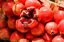 Ripe Pomegranates In A Basket At The Market. Seasonal Fruits